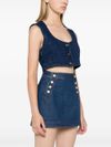 Top crop in denim con scollo ampio