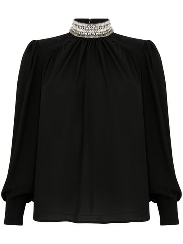 Blusa nera a collo alto con strass