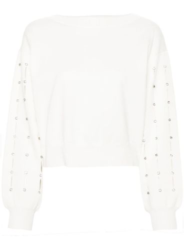 White sweater with rhinestones.