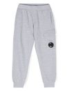 c.p. company - Pantaloni tuta in cotone grigio con tasche e logo lente