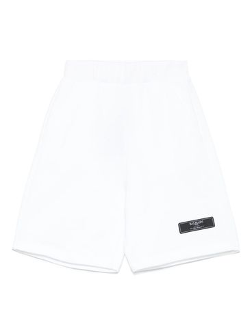 BALMAIN - Shorts bianchi di cotone con patch logo