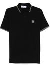 stone island - Polo in cotone nero a maniche corte con righe